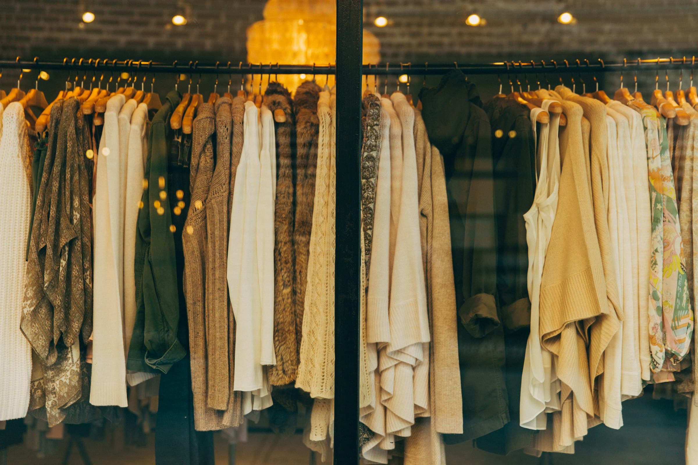 A dimly lit atelier interior, structured garments resting in shadow